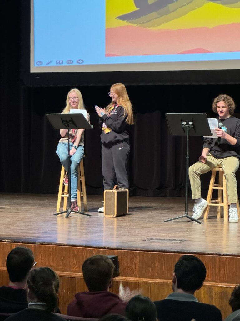 Riverton HS student Sarah Fullmer, won 1st place in the playwriting competition at the Utah Theatre Conference. She is pictured here as RHS actors read her play titled 9:52 at the conference.